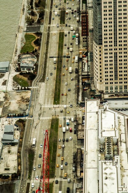 An aerial view of a large-scale construction site showing the development of a modern highway interchange with heavy machinery and workers. The surrounding landscape includes a mix of urban and rural areas.