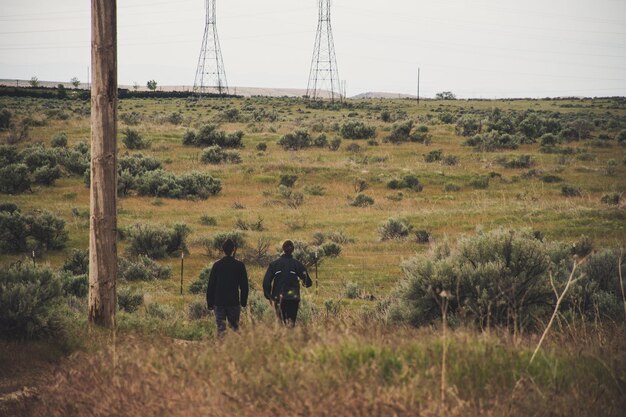 A group of border patrol agents patrolling a remote area near the border, equipped with vehicles and advanced communication devices. The image highlights the role of personnel in maintaining border security.