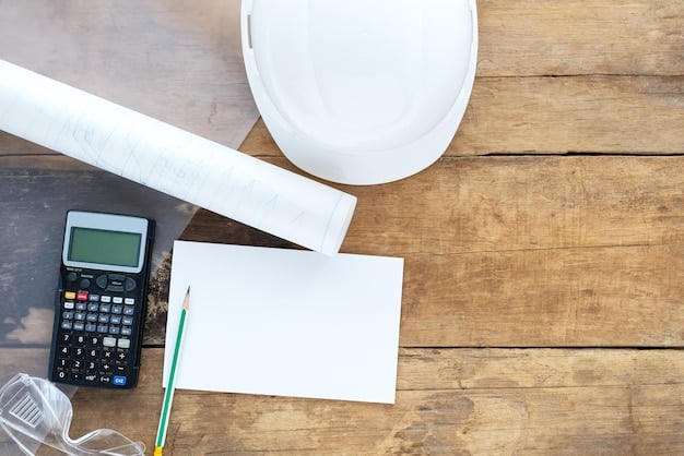 A close-up shot of blueprints spread across a table, with a construction helmet and measuring tape placed on top, symbolizing the planning and precision involved in infrastructure projects.