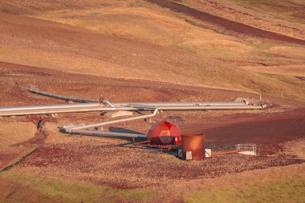 A photograph of the Dakota Access Pipeline construction site, showing heavy machinery laying down sections of the pipeline. Protesters holding signs are visible in the background, separated from the construction by a police line.